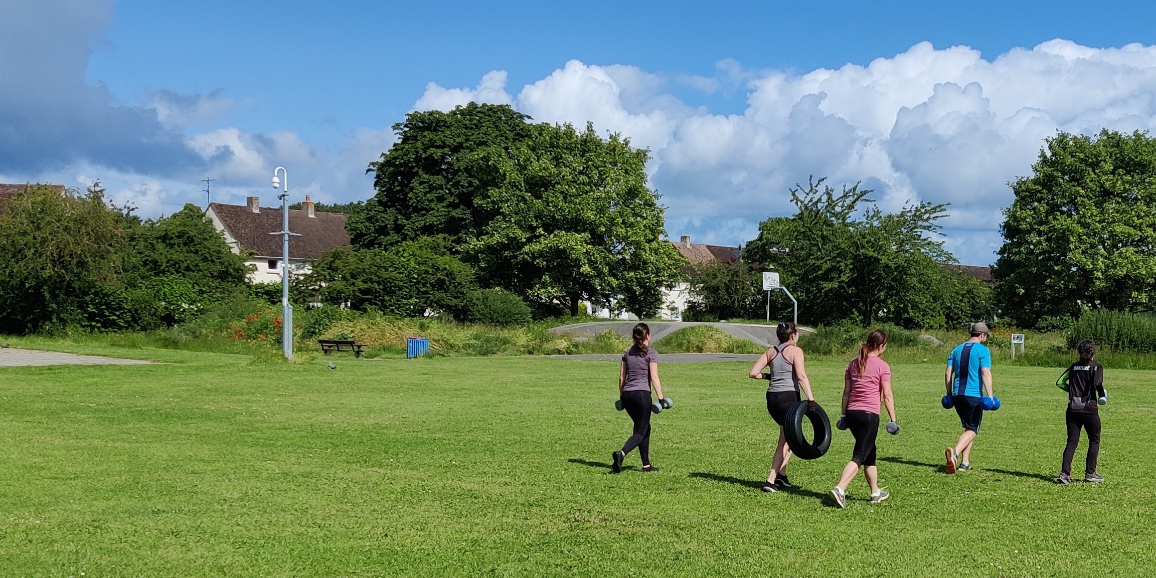 group of people exercising outdoors in a park